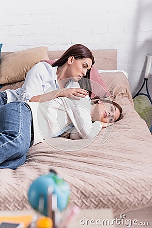 worried mother embracing upset teenage daughter Stock Photo