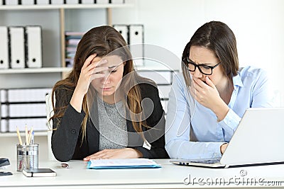 Worried office workers discovering a mistake Stock Photo