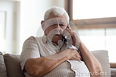 Worried older unhealthy man making emergency 911 call. Stock Photo
