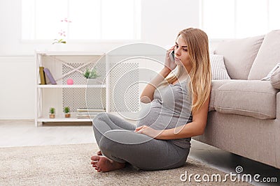 Worried pregnant woman talking on phone copy space Stock Photo