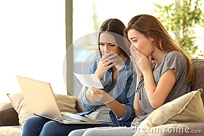 Worried roommates reading a bank notification Stock Photo