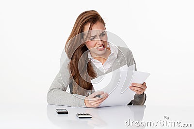 Worried 20s woman classifying administrative documents in office Stock Photo