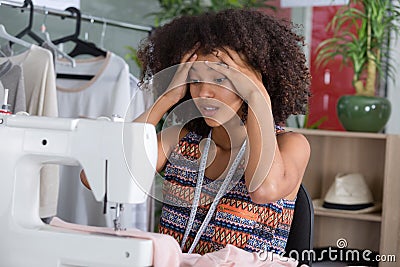 Worried seamstress at work Stock Photo