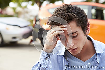 Worried Teenage Driver Sitting By Car After Traffic Accident Stock Photo