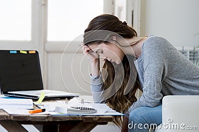 Worried woman suffering stress doing domestic accounting paperwork bills and invoices Stock Photo