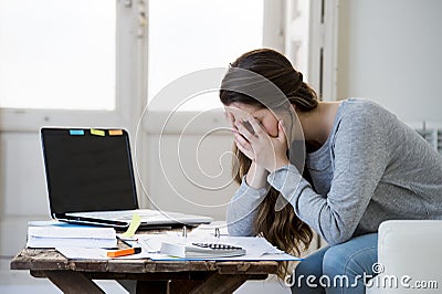 Worried woman suffering stress doing domestic accounting paperwork bills and invoices Stock Photo