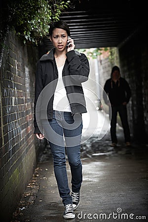 Worried Woman Walking Along Path With Sinister Figure Watching H Stock Photo