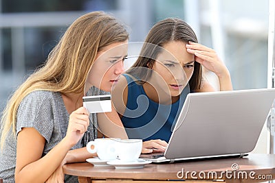 Worried women having problem buying on line Stock Photo