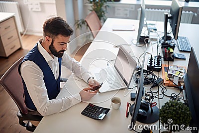 Worried young business man texting on his cell phone. men, modern, office, business, bad news concept Stock Photo