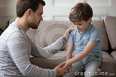 Kind daddy supporting depressed offended small boy. Stock Photo