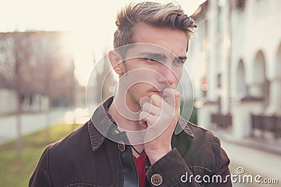 Worried young man biting nails Stock Photo