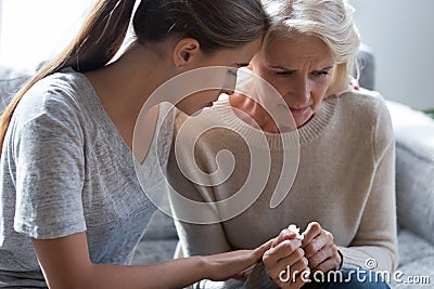 Worrying millennial lady sitting next to upset frustrated mommy. Stock Photo