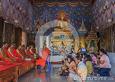 Worshipers and monks praying in Wat Kaew Korawaram Temple Editorial Stock Photo