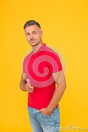 Would you like. Handsome man point finger yellow background. Promoting and marketing. Promoting menswear shop Stock Photo