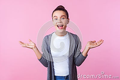Wow awesome! Portrait of happy surprised brunette teenage girl standing with arms raised and mouth open in amazement. indoor Stock Photo