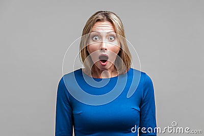 Wow, I can`t believe this! Portrait of astonished woman with stunned shocked face. indoor studio shot isolated on gray background Stock Photo