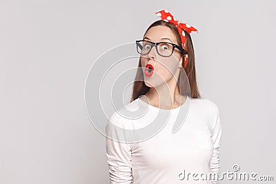 wow its unbelievable, portrait of beautiful emotional young woman in white t-shirt with freckles, black glasses, red lips and Stock Photo