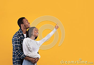 Wow, look at this, it is cool. Romantic surprised smiling young african american students male and woman Stock Photo