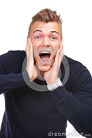 Wow Thats awesome. Studio portrait of an excited young guy yelling in surprise against a white background. Stock Photo