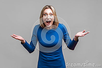 Wow, unbelievable! Portrait of positive astonished woman with widely open mouth and big eyes. isolated on gray background Stock Photo