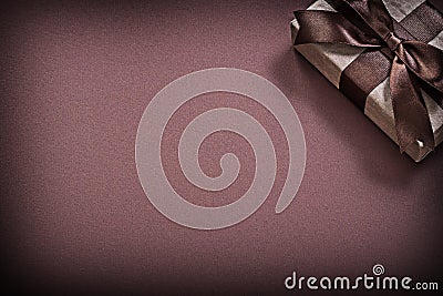 Wrapped gift box on brown background holidays concept Stock Photo