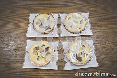 Wrapped sweet pumpkin and sweet potato pies on wooden table Editorial Stock Photo