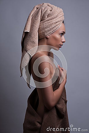 Wrapped in towel over gray background Stock Photo