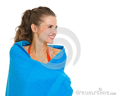 Wrapped in towel smiling young woman in swimsuit Stock Photo