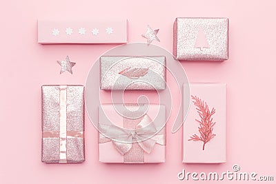 Wrapped xmas boxes. Gift wrapping. Pink nordic christmas gifts isolated on pastel pink background. Stock Photo