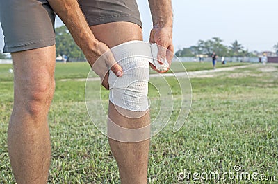 Wrapping knee injury Stock Photo