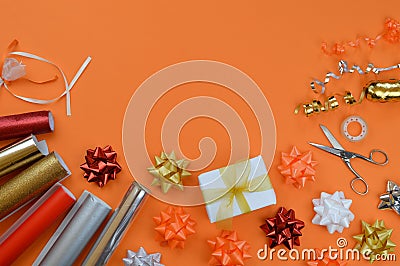 Gift wrapping utensils on orange ground Stock Photo