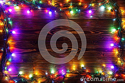 Wreath and garlands of colored light bulbs.Christmas background with lights and free text space. Christmas lights border Stock Photo