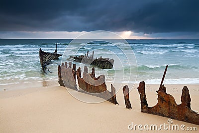 Wreck on australian beach at sunrise Stock Photo