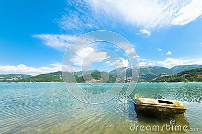 Wreck of a boat on the lake in perspective Stock Photo