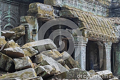 The wreckage of the temples of Angkor Wat on the background of preserved buildings Stock Photo