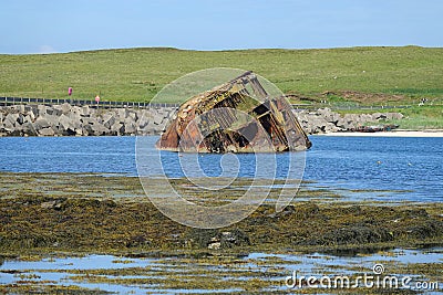 Wrecked block ship and concrete causeway Stock Photo