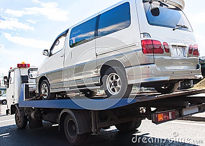 Wrecker transports broken miniveins Stock Photo