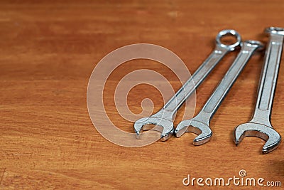 Wrench hand tool of master on wooden table Stock Photo