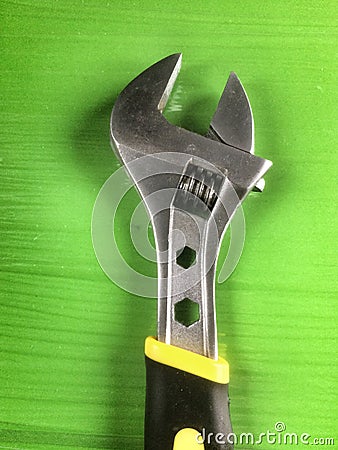 Wrench tool on green background Stock Photo