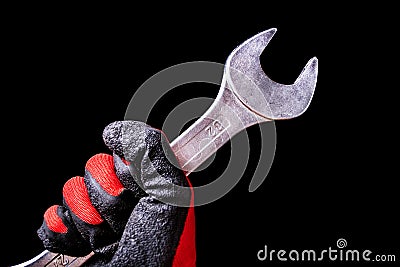 Precision in Motion: Chrome Wrench Tool in Hand with Protective Gloves - Mechanical Mastery Stock Photo
