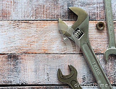 Wrenches on a background of colored wooden surface. Space for text. Background for business, industry Editorial Stock Photo