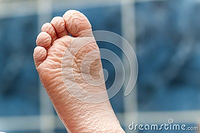 Wrinkled bare feet coming out from a bathtub. Young person getting a bath feet close-up indoor in bathroom interrior photo Stock Photo