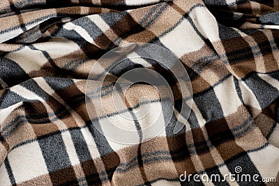 Wrinkled black and brown checkered clothing background. Fabric with a pattern of black white brown cells Stock Photo