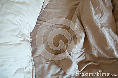 Wrinkled sheet pillows blanket bed home textile Stock Photo