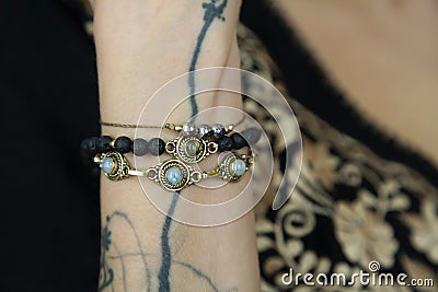 Wrist detail wearing collection of bracelets Stock Photo