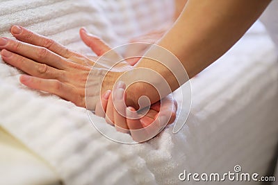 Wrist massage. massage therapist puts pressure on a sensitive point on a woman& x27;s hand. Physiotherapist massaging her Stock Photo