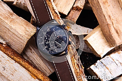 Wrist watch men`s brown leather strap on wood. Stock Photo