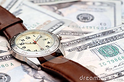 A wristwatch on American currency Stock Photo