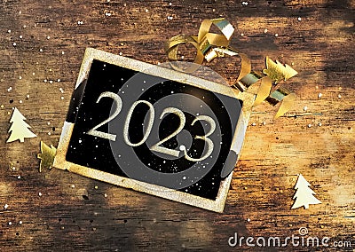 2023 writen on a black little board on illuminated wooden background Stock Photo