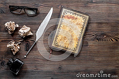 Writer concept. Feather pen, vintage notebook and crumpled paper on wooden table background top view copyspace Stock Photo